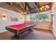 Bright game room with a red felt pool table and plenty of windows with an outside view at 13618 Greenfield Dr # 105, Tampa, FL 33618