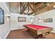 Bright game room with a red felt pool table under a unique light fixture and exposed beam ceiling at 13618 Greenfield Dr # 105, Tampa, FL 33618