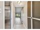 Hallway with hardwood flooring and view to the living room featuring natural light at 13618 Greenfield Dr # 105, Tampa, FL 33618