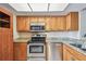 Updated kitchen featuring stainless steel appliances, granite countertops, and wood cabinets at 13618 Greenfield Dr # 105, Tampa, FL 33618