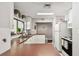 Clean kitchen with white cabinetry, practical layout, and natural lighting at 13618 Greenfield Dr # 105, Tampa, FL 33618