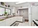 Practical kitchen features white cabinetry and appliances for easy meal preparation at 13618 Greenfield Dr # 105, Tampa, FL 33618