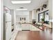 Bright kitchen featuring a stainless steel sink, white cabinets, and pass-through to the dining area at 13618 Greenfield Dr # 105, Tampa, FL 33618