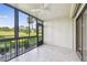 Screened in lanai offers a serene view of the surrounding green space at 13618 Greenfield Dr # 105, Tampa, FL 33618
