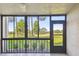 Screened lanai with ceiling fan and views of the lush green landscape at 13618 Greenfield Dr # 105, Tampa, FL 33618