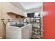 Functional laundry room featuring a washer, dryer, and shelving for storage at 13618 Greenfield Dr # 105, Tampa, FL 33618