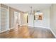 Bright living room with hardwood floors and view into the kitchen at 13618 Greenfield Dr # 105, Tampa, FL 33618