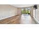 Spacious living room with a sliding glass door and hardwood floors at 13618 Greenfield Dr # 105, Tampa, FL 33618