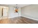 Open living room with hardwood floors and view into the kitchen at 13618 Greenfield Dr # 105, Tampa, FL 33618