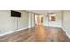 Open-concept living room with hardwood floors and view into the kitchen at 13618 Greenfield Dr # 105, Tampa, FL 33618