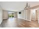 Open living room with hardwood floors, chandelier, and sliding glass door at 13618 Greenfield Dr # 105, Tampa, FL 33618