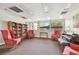 Comfortable lounge featuring cozy seating, a bookshelf, a piano, and ample natural light at 13618 Greenfield Dr # 105, Tampa, FL 33618