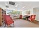 Lounge offering cozy seating, bookshelf, piano, and natural light, creating a serene atmosphere at 13618 Greenfield Dr # 105, Tampa, FL 33618