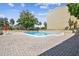 Inviting community pool with brick pavers and clear blue water on a sunny day at 13618 Greenfield Dr # 105, Tampa, FL 33618