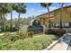 Community signage surrounded by lush landscaping and mature palm trees under a sunny sky at 13618 Greenfield Dr # 105, Tampa, FL 33618
