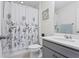 Bathroom features gray cabinetry and white countertops, plus a shower-tub combination at 14110 Damselfly Dr, Tampa, FL 33625