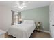 Cozy bedroom featuring a ceiling fan, neutral walls, and a bright window at 14110 Damselfly Dr, Tampa, FL 33625
