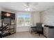 Bedroom with a mounted television, computer desk, brick accent wall, and a ceiling fan at 14110 Damselfly Dr, Tampa, FL 33625