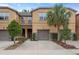 Inviting townhome showcasing stucco facade, well-manicured landscaping, and a private single-car garage at 14110 Damselfly Dr, Tampa, FL 33625