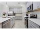 Spacious kitchen with stainless steel appliances, sleek countertops, and ample cabinet storage at 14110 Damselfly Dr, Tampa, FL 33625