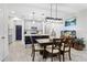 The kitchen and dining area feature an island with seating and stainless steel appliances at 14110 Damselfly Dr, Tampa, FL 33625