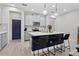 Modern kitchen features an island with bar seating, white countertops, and stainless steel appliances at 14110 Damselfly Dr, Tampa, FL 33625