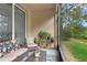 Cozy screened lanai with comfortable seating, plants, and view of the green backyard at 14110 Damselfly Dr, Tampa, FL 33625
