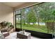 Relaxing screened lanai with comfortable seating and serene lake view at 14110 Damselfly Dr, Tampa, FL 33625