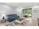 Stylish living room featuring modern decor and sliding glass doors to the outside at 14110 Damselfly Dr, Tampa, FL 33625