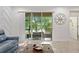 Bright living room with stylish decor and scenic views through sliding glass doors at 14110 Damselfly Dr, Tampa, FL 33625