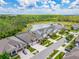 Aerial view of a residential area with a lake and surrounding greenery at 16712 Courtyard Loop, Land O Lakes, FL 34638
