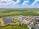 This high-angle view shows how close this home is to community lakes and mature trees at 16712 Courtyard Loop, Land O Lakes, FL 34638