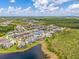 An aerial view reveals the neighborhood's layout, surrounded by lush greenery and community lakes at 16712 Courtyard Loop, Land O Lakes, FL 34638