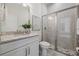 Well-lit bathroom featuring a granite vanity, tiled shower, and elegant finishes at 16712 Courtyard Loop, Land O Lakes, FL 34638