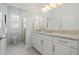 Bright bathroom with granite countertop, toilet, and a glass-enclosed shower at 16712 Courtyard Loop, Land O Lakes, FL 34638