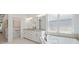 Bright bathroom with granite countertop and a large tub by the window at 16712 Courtyard Loop, Land O Lakes, FL 34638