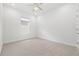 Neutral-toned bedroom with plush carpeting and large window at 16712 Courtyard Loop, Land O Lakes, FL 34638