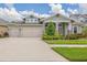 Charming single-Gathering home with a well-manicured lawn and a three-car garage at 16712 Courtyard Loop, Land O Lakes, FL 34638