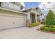 Charming home featuring a three-car garage and beautifully landscaped front yard at 16712 Courtyard Loop, Land O Lakes, FL 34638