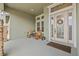 Cozy front porch with seating area and decorative wreath on the front door at 16712 Courtyard Loop, Land O Lakes, FL 34638