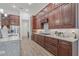 Gourmet kitchen with cherry wood cabinets, granite countertops, and stainless steel appliances at 16712 Courtyard Loop, Land O Lakes, FL 34638