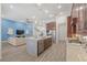 Spacious kitchen showcasing a central island with stainless steel appliances, flowing into the living area at 16712 Courtyard Loop, Land O Lakes, FL 34638