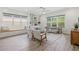 Spacious living room featuring bright windows, tile flooring, and comfortable seating at 16712 Courtyard Loop, Land O Lakes, FL 34638