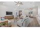 Open living space with modern furniture, tile floors, and easy access to the dining area at 16712 Courtyard Loop, Land O Lakes, FL 34638