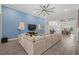 Comfortable living room featuring an inviting L-shaped sofa, stylish decor, and open flow to the dining area at 16712 Courtyard Loop, Land O Lakes, FL 34638