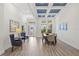 Elegant dining area featuring wood-look tile flooring and large windows at 16712 Courtyard Loop, Land O Lakes, FL 34638