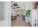 Bright, open-concept living area with coffered ceilings and wood-look tile flooring at 16712 Courtyard Loop, Land O Lakes, FL 34638