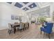 Spacious dining area open to the living room, featuring wood-look tile floors at 16712 Courtyard Loop, Land O Lakes, FL 34638