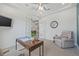 View of home office with white trim, double doors, TV and comfortable recliner at 16712 Courtyard Loop, Land O Lakes, FL 34638