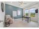 Bright home office with large windows, a ceiling fan, and a comfortable recliner at 16712 Courtyard Loop, Land O Lakes, FL 34638
